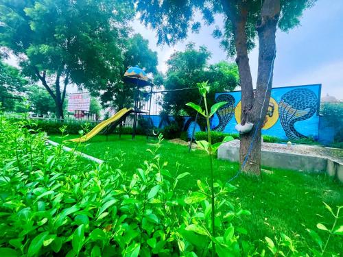 a park with a playground with a slide at Tata Vista Resort, Vrindavan - #big swimming pool #luxury rooms #gardens #playing zone #away from city hustle # BY ELEGANCE GROUP# in Vrindāvan