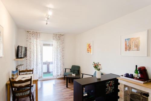 a living room with a tv and a window at Ferien Weingut Schneider in Ellenz-Poltersdorf