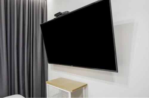 a flat screen tv hanging on a wall at Hotel Yaja Gwangju Mudeungsan branch in Gwangju