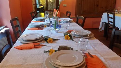 a long table with plates and glasses on it at Agriturismo Saudon in Mulazzo