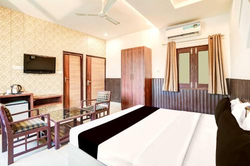 a hotel room with a bed and a television at Hotel O Civil Lines Rudrapur in Rudrapur
