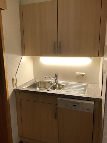a small kitchen with a sink and a light at Ferienwohnung Salzgeber in Tschagguns