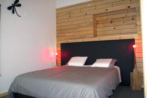 a bedroom with a large bed with a wooden headboard at Stone Station in Esneux