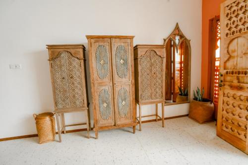 a room with two wooden cabinets and a window at La Marrocco Villas in Nusa Penida
