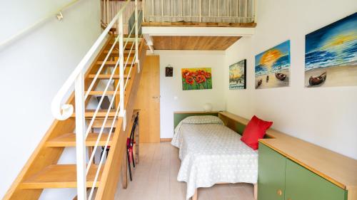 a bedroom with a bed and a staircase in a house at Casa delle Viole in Terranuova Bracciolini