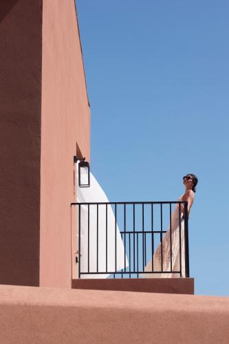 a man standing on a staircase next to a building at Arcasa Villas Collection by Omilos Hotels in Archanes