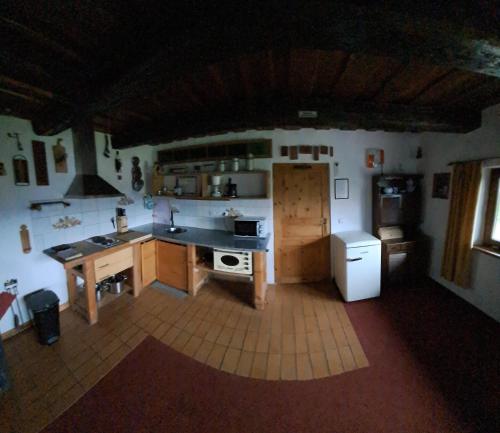 a kitchen with a stove and a counter top at Chalupa na Maňavě in Maňava
