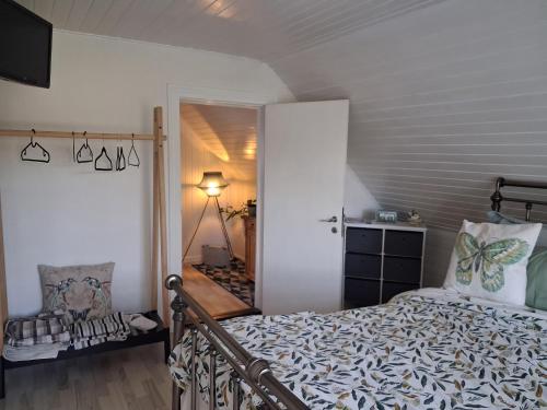 a bedroom with a bed and a door to a hallway at KRAGKAER Deer-Lodge B&B & Guest House - Unique Holiday Homes in Sæby