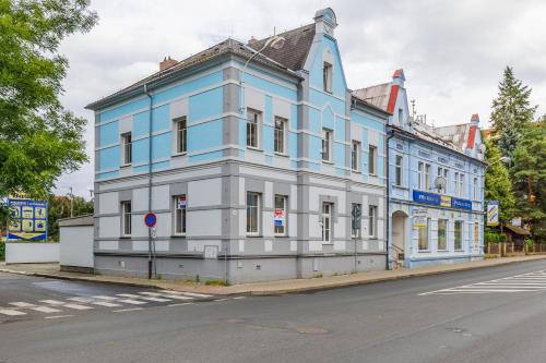 a blue and white building on the side of a street at Vila Anna - Apartmány in Česká Lípa