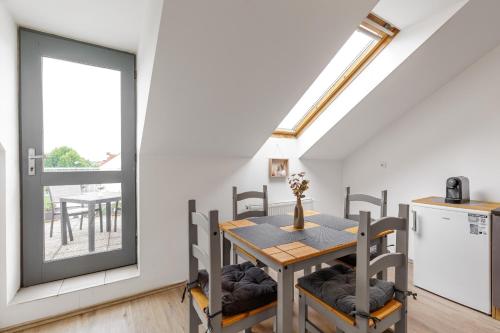 a kitchen and dining room with a table and chairs at Vila Anna - Apartmány in Česká Lípa