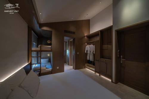 a bedroom with a bed and a walk in closet at Harvest Day Hoi An in Hoi An