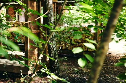 a tree in front of a house with a fence at SANU 2nd Home AMATSUMI 安曇野 in Azumino