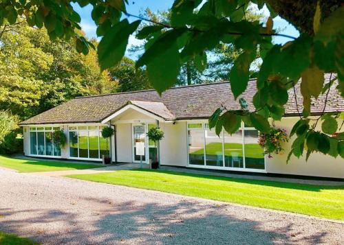 a house with a lot of windows at Woodovis Park in Tavistock