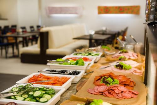a buffet line with many different types of food at Park Inn by Radisson Sarvar Resort & Spa - All Inclusive in Sárvár
