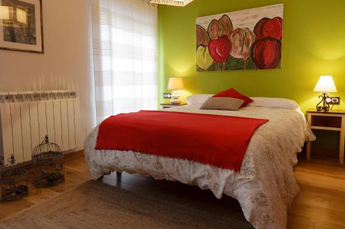 a bedroom with a bed with a red blanket at Gure Idorpea in Lesaka