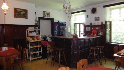 a bar in a restaurant with chairs and tables at Hotel Hubert in Hřensko