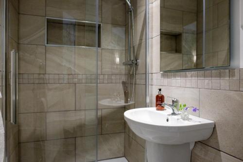 a bathroom with a sink and a shower at 1863 Restaurant with Rooms in Pooley Bridge