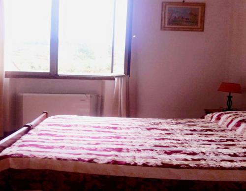 Una cama o camas en una habitación de B&B Locanda La Rotonda