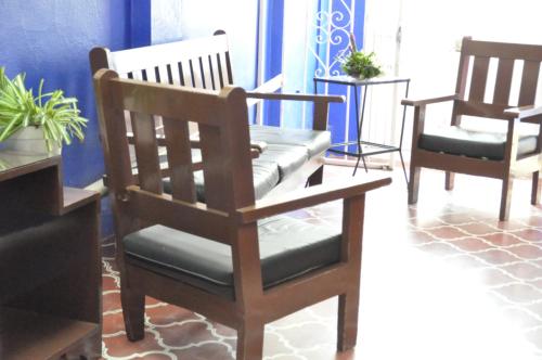 two wooden chairs sitting in a room with at Hotel Metropolitan II in Irapuato