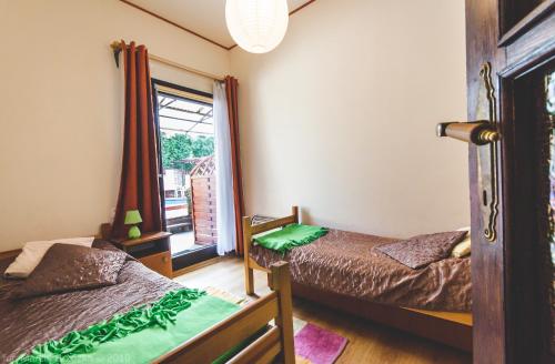 a bedroom with two beds and a window at O.W. Blue Cafe in Krościenko