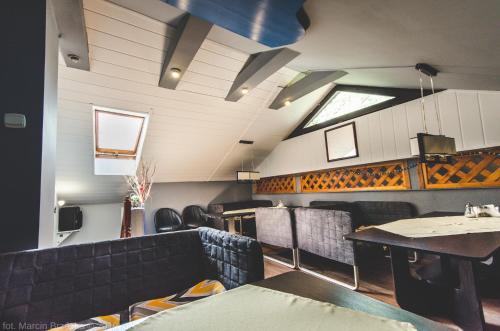 a dining room with black chairs and a table at O.W. Blue Cafe in Krościenko