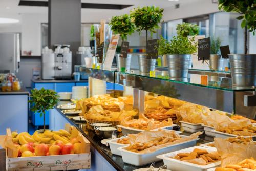 a buffet line with different types of food on display at Park Inn by Radisson Sarvar Resort & Spa - All Inclusive in Sárvár