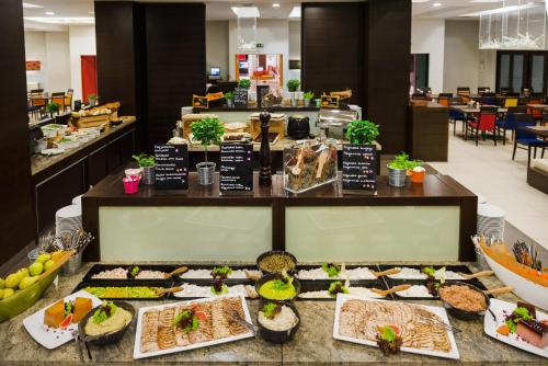 a buffet line with many different types of food at Park Inn by Radisson Sarvar Resort & Spa - All Inclusive in Sárvár