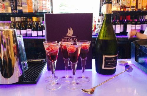 a group of wine glasses on a counter with a bottle of wine at Boutique By Browns in Worcester