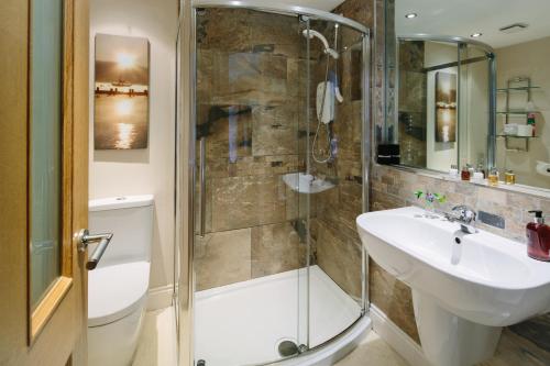 a bathroom with a shower and a sink and a toilet at 1863 Restaurant with Rooms in Pooley Bridge