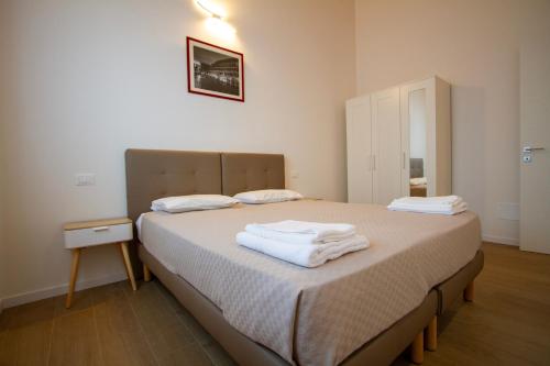 a bedroom with a bed with towels on it at Altichiero 105 in Padova