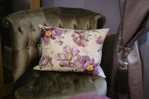 a pillow sitting on top of a chair at 1863 Restaurant with Rooms in Pooley Bridge