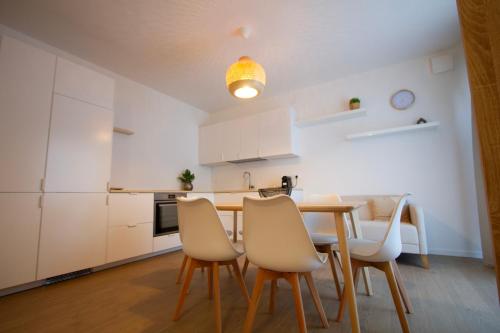 a kitchen and dining room with a table and chairs at Altichiero 105 in Padova