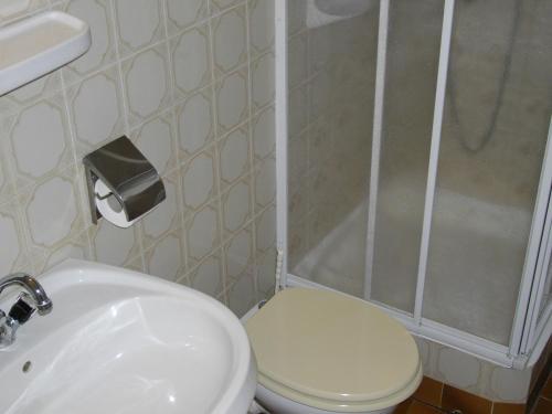 a bathroom with a toilet and a sink and a shower at Petra Vendégház in Bük