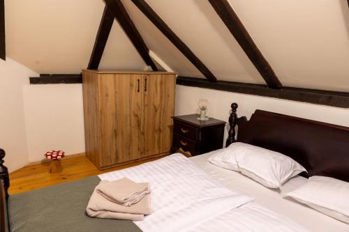a bedroom with a bed and a wooden ceiling at Hilltop House. in Erdut