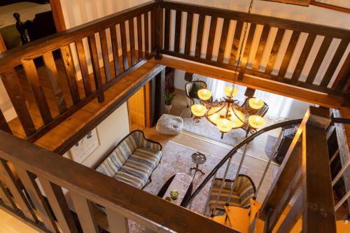 an overhead view of a living room with a staircase at Hilltop House. in Erdut
