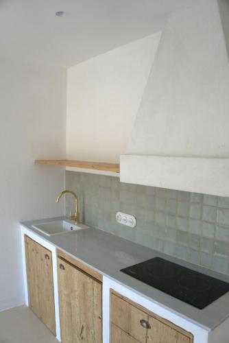 a kitchen with a sink and a counter top at Ses Terrisses Hotel in Palafrugell