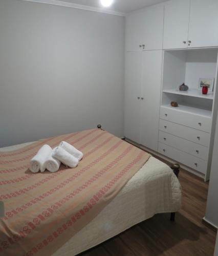a bedroom with a bed with two towels on it at Rodonas-Apartments in Volissos