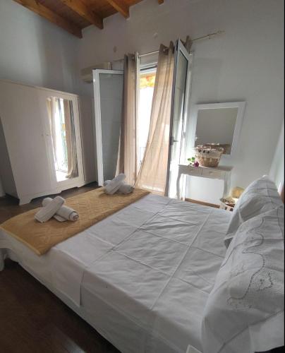 a bedroom with a large bed with two towels on it at Anna's Apartment in Gaios