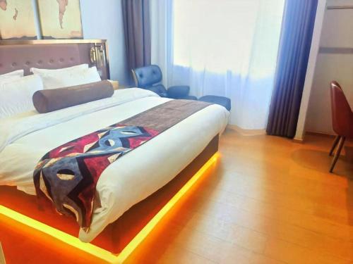 a bedroom with a bed with a blanket on it at James Joyce Coffetel·Lijiang Old Town Centeral in Lijiang