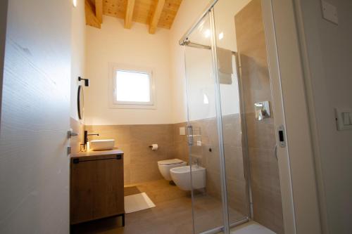 a bathroom with a toilet and a glass shower at Altichiero 105 in Padova