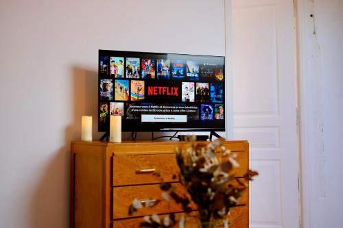 a tv sitting on top of a dresser with a dresser at Verneuil sur Avre - Romantic room in Verneuil d’Avre et d’Iton
