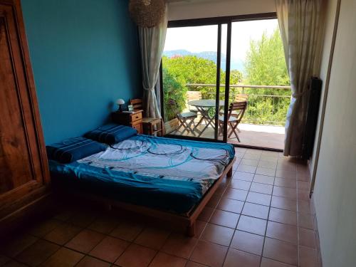 une chambre avec un lit et un balcon avec une table dans l'établissement Maison presqu'île de Giens, à Hyères