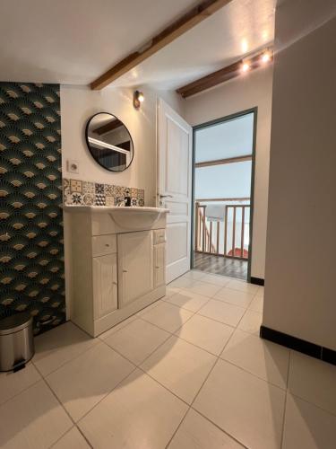 a bathroom with a sink and a view of the ocean at Les gîtes du pied mulet in La-Gripperie-Saint-Symphorien