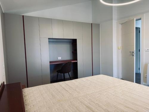 a bedroom with a bed and a desk and a chair at Residenza esclusiva appena costruita in Imola