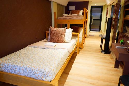 a dorm room with bunk beds and a hallway at Sunset View Ridge Residences in Baguio