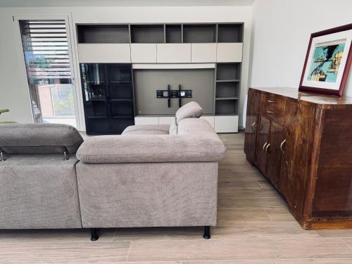 a living room with two couches and a fireplace at Residenza esclusiva appena costruita in Imola