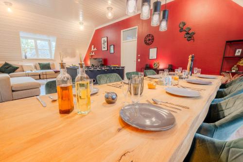 a long wooden table with plates and glasses on it at Rheinsteig Chalét Bendorf in Bendorf