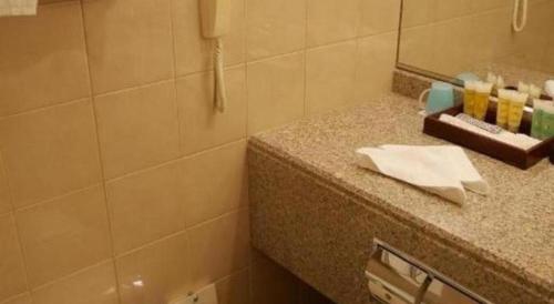 a bathroom with a counter with a sink and a mirror at Yokohama Royal Park Hotel in Yokohama