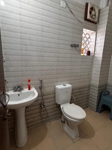 a bathroom with a toilet and a sink at Bihar stay properties 2 bhk in Patna