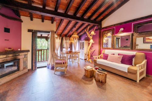a living room with a couch and a table at Apartamentos Rurales & Spa La Bárcena in Enterria